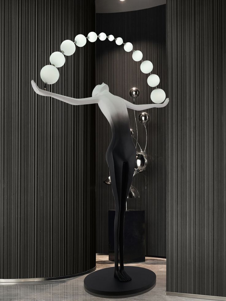 Designer Black White sculpture holding ball floor lamp
